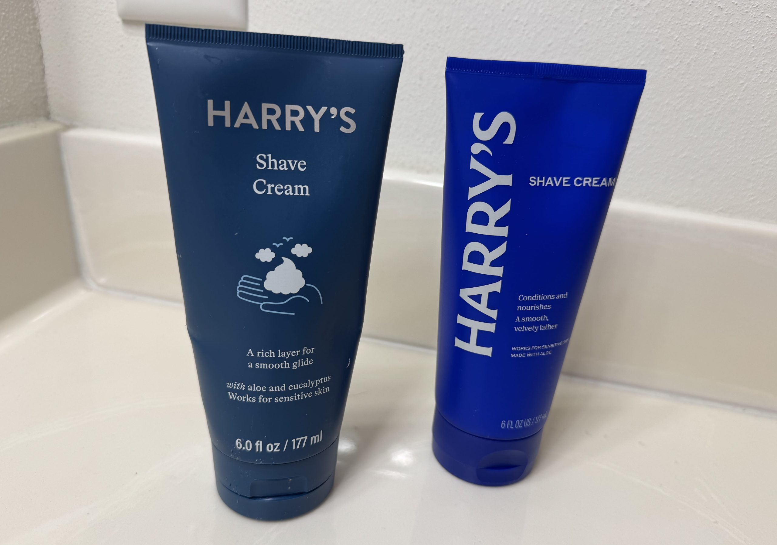 The old and new Harry's shave cream bottles.